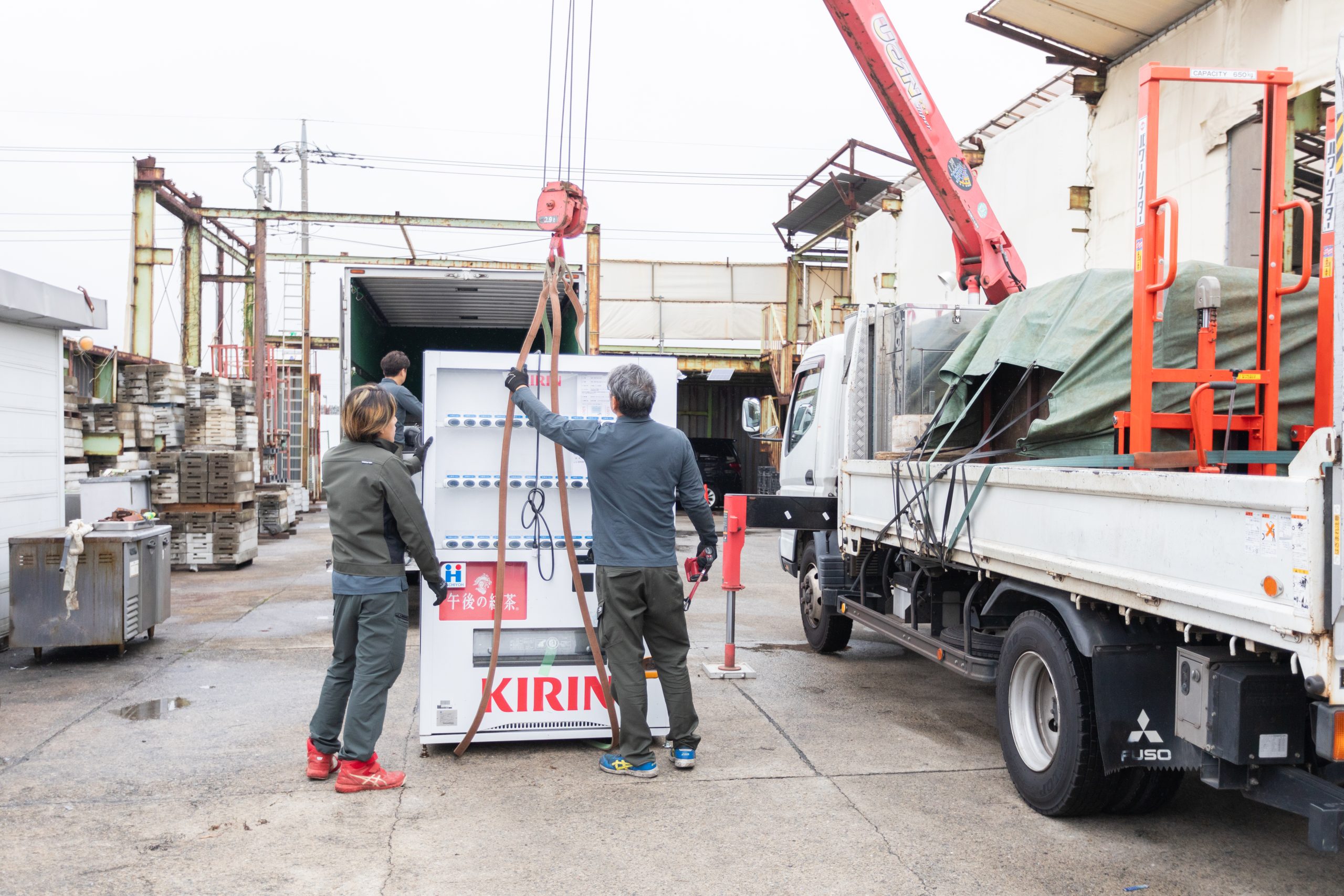 クレーンで自動販売機を釣る作業